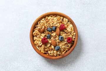 Delicious granola with berries on a light background