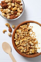 Delicious granola with yogurt on a light background