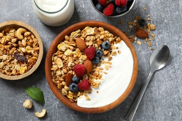 Delicious granola with berries and yogurt on a light background