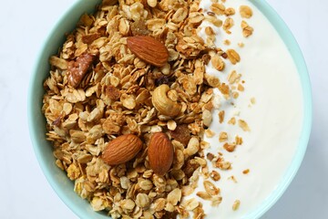 Delicious granola with yogurt on a light background
