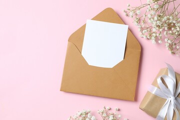 Top view photo with gypsophila flowers and envelope  on color background 