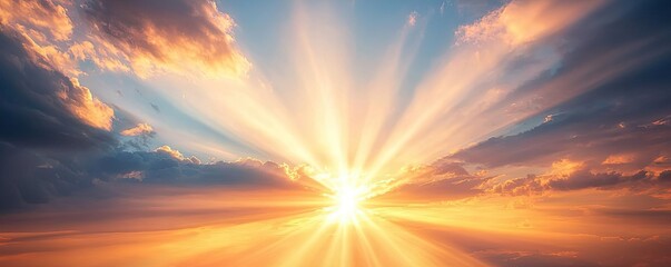 Beautiful sunrise with rays of light breaking through clouds in the sky.