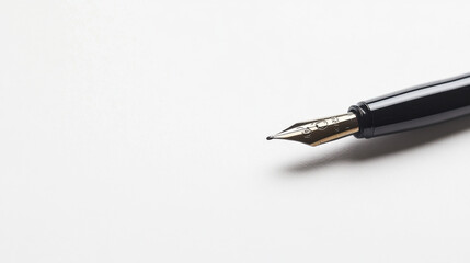 Sleek fountain pen on a blank white surface, symbolizing elegance and creativity with its shiny metallic nib and black handle.