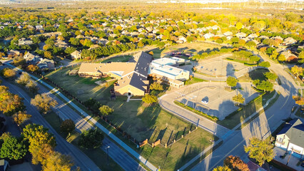 Elementary school with large outdoor space, soccer field situated in upscale residential area in...