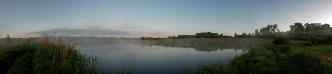 Panorama lake view in sunrise time.Sunrise at the lake