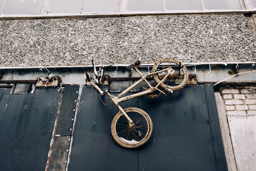 Golden Bicycle Installation on Industrial Wall