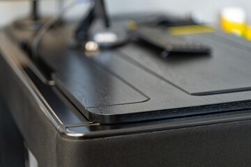 Mobile phone with wireless charger on table. Modern workplace accessory