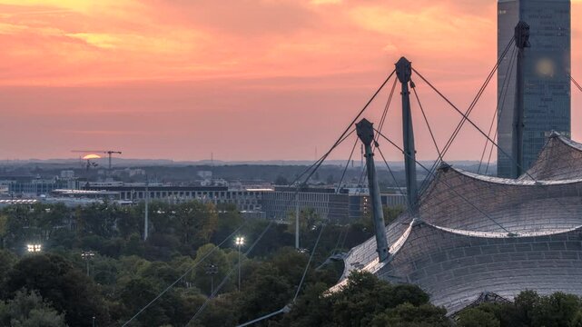 Sunser over Munich city skyline soccer arena olympia park skyscrapers buildings, munchen germany.