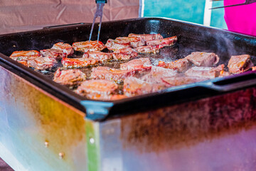 Juicy Steaks Being Grilled on a Hot BBQ Grill at an Outdoor Cookout, Highlighting Sizzling Meat and Smoky Flavor, Perfect for a Summer Barbecue or Outdoor Party Gathering Setting