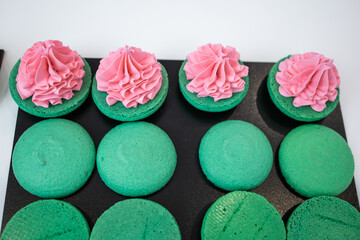 Green macaroons. Sweets. Pink filling for macaroons. Delicious pastries