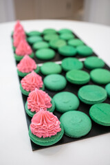 Green macaroons. Sweets. Pink filling for macaroons. Delicious pastries