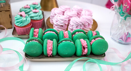 Green macaroons. Sweets. Pink filling for macaroons. Delicious pastries. Candy