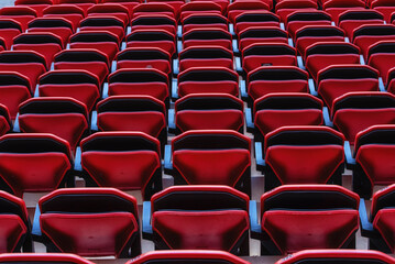 Perspective of many empty red stadium seats
