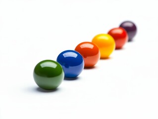 Colorful glossy spheres aligned diagonally on white.