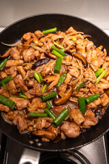 Chicken and mushroom stir fry in the frying pan.