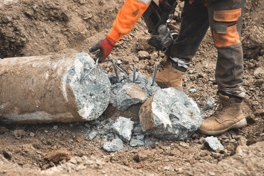 Construction worker preparing concrete pile for foundation works