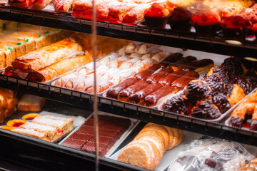 Assortment of Freshly Baked Pastries and Desserts on Display in a Bakery Shop Showcasing Cannoli, Eclairs, Cookies, and Cakes, Perfect for Sweet Indulgence and Culinary Inspiration for Pastry Lovers