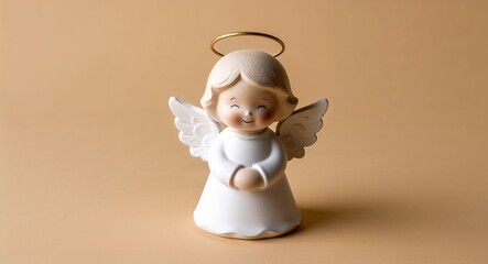 A sweet angel figurine with a halo and angelic smile on a plain warm cream background