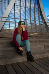 Sporty woman wearing inline skates and enjoying a sunny day