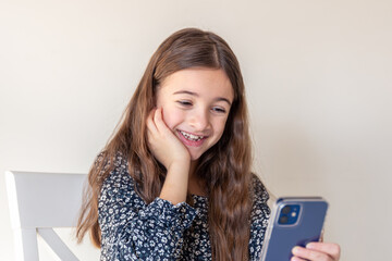 Happy girl with phone. Portrait of attractive cheerful amazed girl using phone.