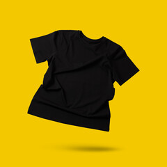 Black t-shirt in air on golden background