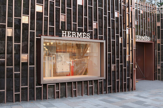 TOKYO, JAPAN - December 5, 2024: Front of a Hermes store in Tokyo's Omotesando area. Its window display is being changed.