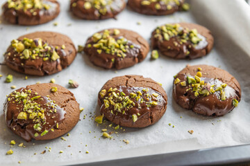 Chocolate Cookies Covered with Chocolate and Sprinkled with Chopped Pistachios – Perfect for Christmas 