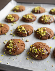 Chocolate Cookies Covered with Chocolate and Sprinkled with Chopped Pistachios – Perfect for Christmas 