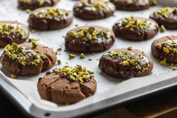 Chocolate Cookies Covered with Chocolate and Sprinkled with Chopped Pistachios – Perfect for Christmas 