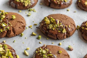 Chocolate Cookies Covered with Chocolate and Sprinkled with Chopped Pistachios – Perfect for Christmas 
