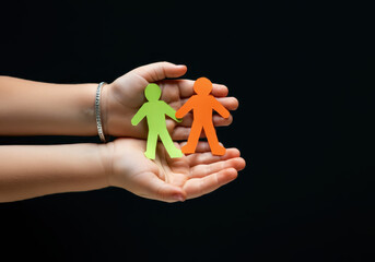 Little Hands Holding Vibrant Paper People Highlighting Autism Awareness, Community Support, and Happy Family Moments