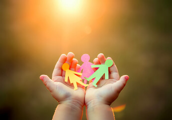 Little Hands Cradling Bright Paper Figures Reflecting Family Bonding, Autism Awareness, and a Happy Community Spirit