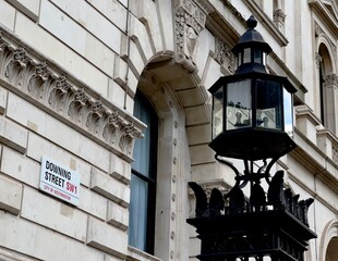 Downing Street sign on the wall of a British government building in Westminster, London, UK.  