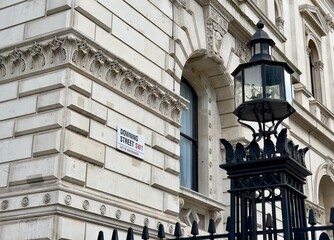 Downing Street sign on the wall of a government building in Westminster, London, England. 