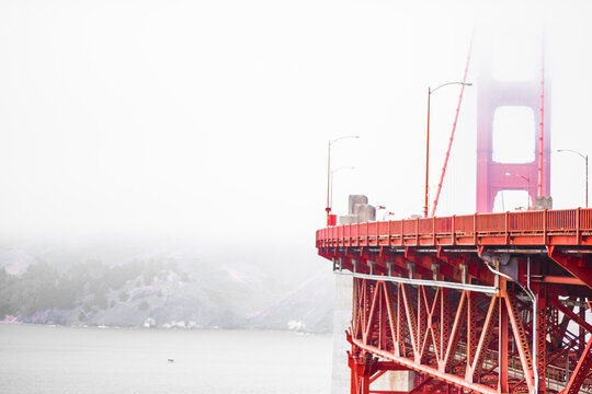 Golden Gate Bridge Partially Obscured by Dense Fog Over San Francisco Bay on a Misty Day Creating a Mysterious and Enigmatic Coastal Atmosphere in Iconic Californian Landscape