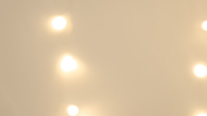 Soft blurred golden and brown bokeh with warm Christmas light reflections.