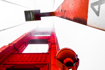 Dramatic Angle of Red Bridge Tower on a Foggy Day with Modern Architectural Elements and Industrial Design Features