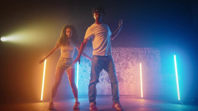 Emotional dance of couple of black woman and man, charismatic talented dancers. Move body and listen to music, African American young people hanging on dance party, expressing feelings and emotions