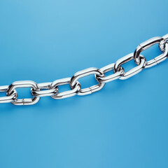 Obraz premium Metallic link chain on vibrant blue background showcasing industrial strength and design in modern technology setting for various creative projects