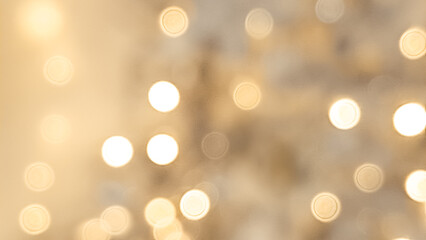  Blurred golden and light brown bokeh background with soft Christmas lights.