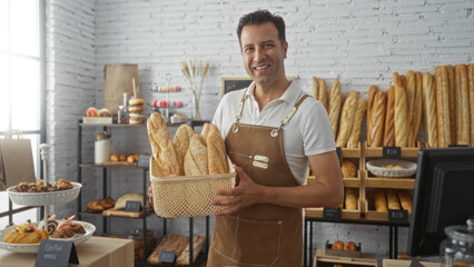 Hispanic man holding a basket of fresh bread in an indoor bakery shop with an array of baked goods...