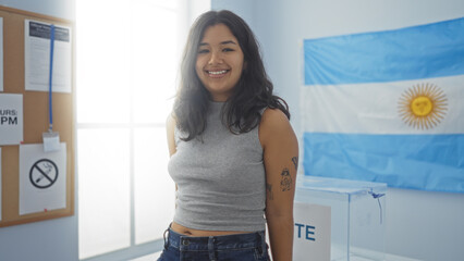Young brunette woman standing in an indoor argentinian electoral room with a flag in the...