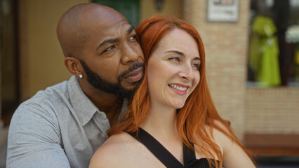 Interracial couple smiling on an urban street having a close moment, reflecting love, togetherness, and family bonds in an outdoors city setting