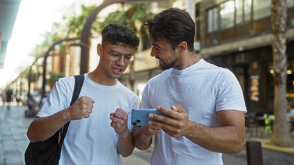 Father and son smiling together looking at a smartphone while standing on an urban street in a city, embodying family love, connection, and happiness in an outdoor setting.