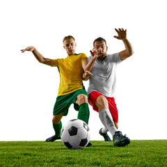 Two players competing for ball control on green soccer stadium against white studio background, shows their intense focus. Concept of sport event, championship, motion, match. Ad