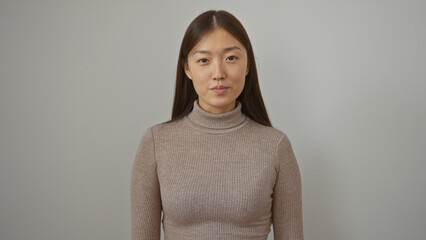 Woman standing in front of a white background, young and beautiful, with long hair, wearing a...