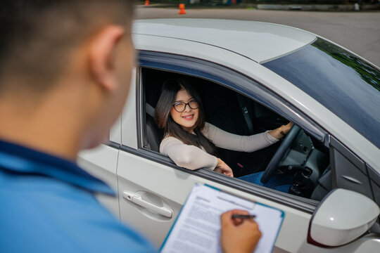 An instructor thoroughly evaluates a student during the driving proficiency test to assess skills