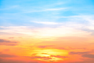 Obraz premium Sky,sunset, beautiful , luxury soft gradient orange gold clouds and sunlight on the blue sky perfect for the background, Sunrise on morning or everning in winter warm time ,Twilight summer,silhouette