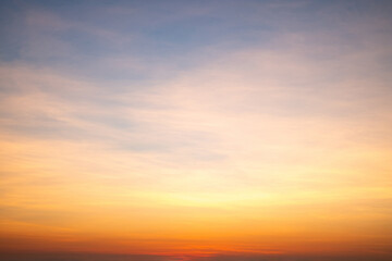 Obraz premium Sky,sunset, beautiful , luxury soft gradient orange gold clouds and sunlight on the blue sky perfect for the background, Sunrise on morning or everning in winter warm time ,Twilight summer,silhouette