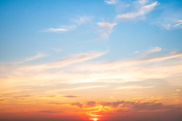 Fototapeta premium Sky,sunset, beautiful , luxury soft gradient orange gold clouds and sunlight on the blue sky perfect for the background, Sunrise on morning or everning in winter warm time ,Twilight summer,silhouette